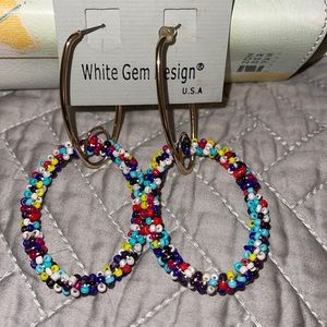 Multicolor and gold drop down hoop earrings.